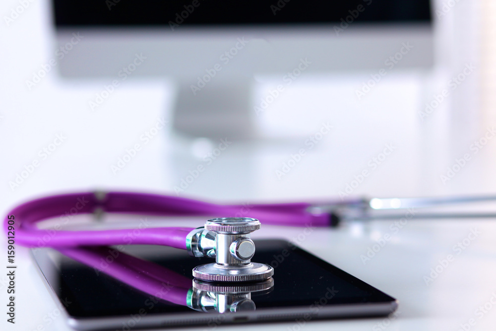 Stethoscope with a tablet computer lie on a table Stethoscope with a tablet computer lie on a table