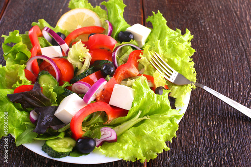 Fresh vegetables on wooden and blur background photo