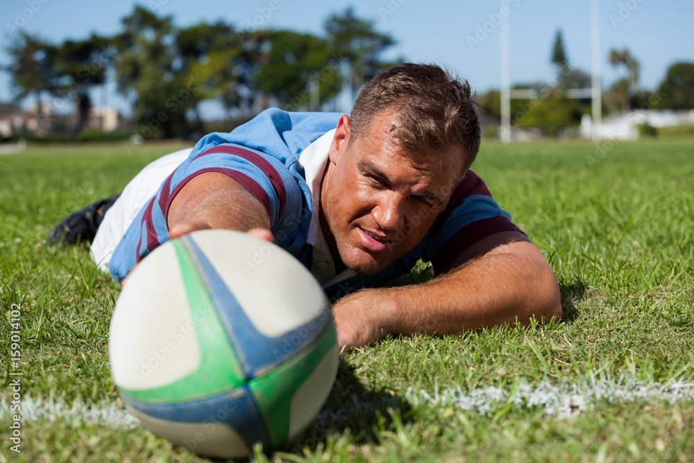 Player holding rugby ball on goal post line Player holding rugby ball on goal post line
