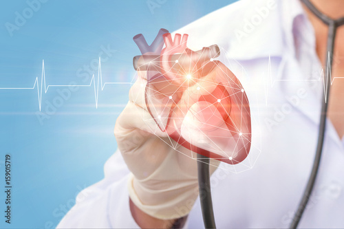 Cardiologist listens to the heart .