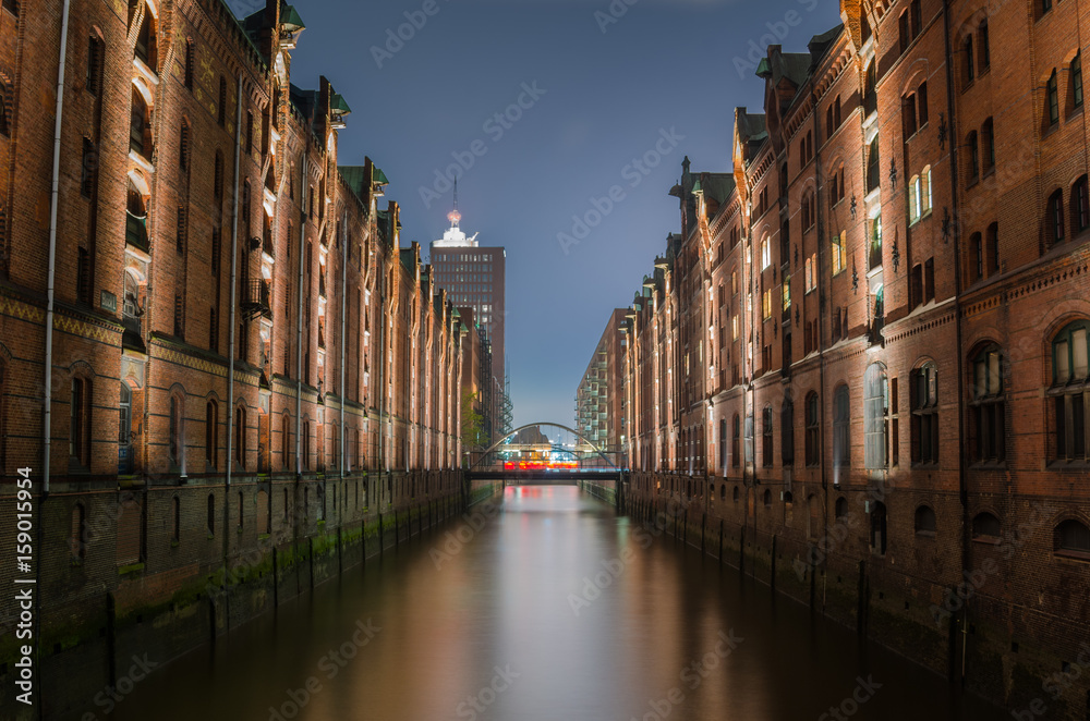 Historic Warehouse District in Hamburg, Germany, at Night. Reflection in Water.