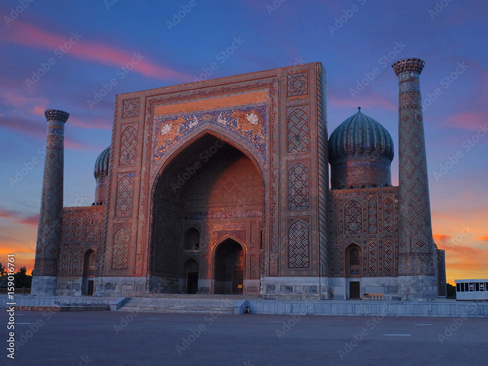 Sunset shot from Registan Square of Sher Dor Madrasah, Samarkand, Uzbekistan. sunset with red lights and in Registan Square in Smarkand. Front view of most famous silk road picture, the Sher-Dor Madra