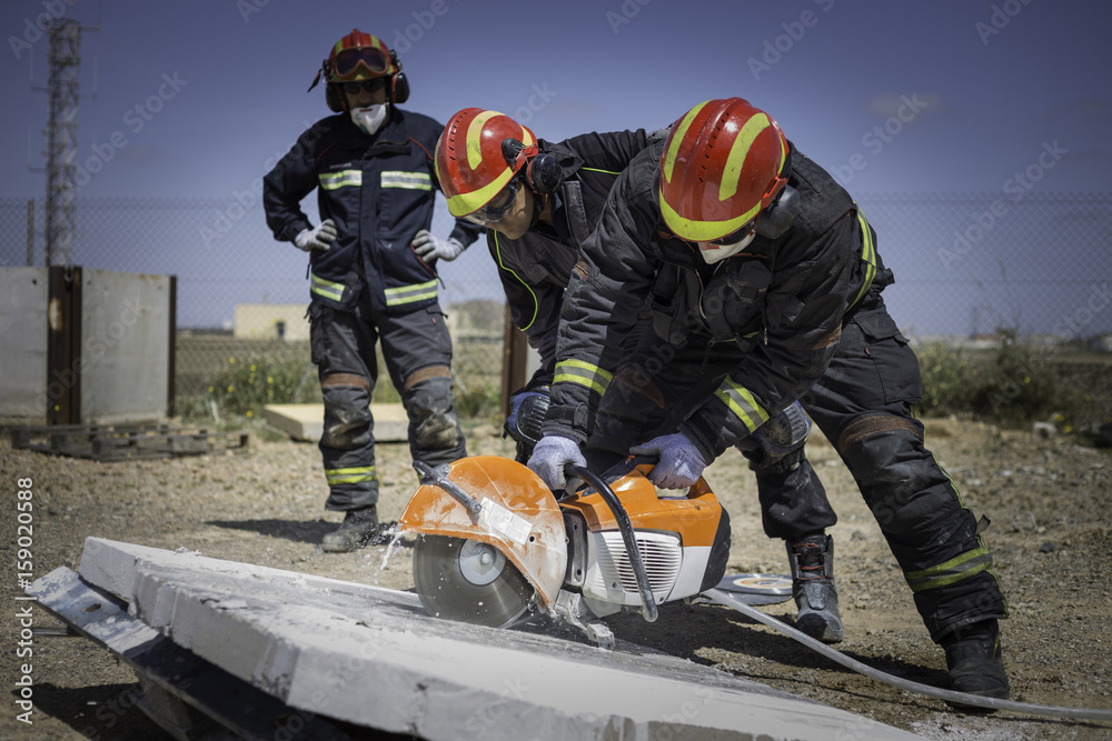 Fototapeta premium Firefighter practicing with a disc cutter