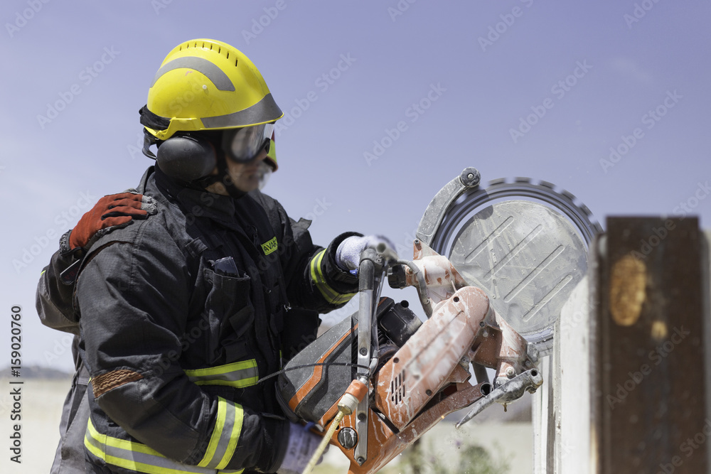 Firefighter practicing with a disc cutter Firefighter practicing with a disc cutter