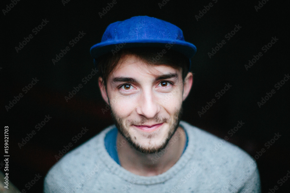 Portrait of a young man in a blue hat Portrait of a young man in a blue hat