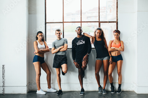 Portrait of multiethnic group of athletes standing in the gym  photo