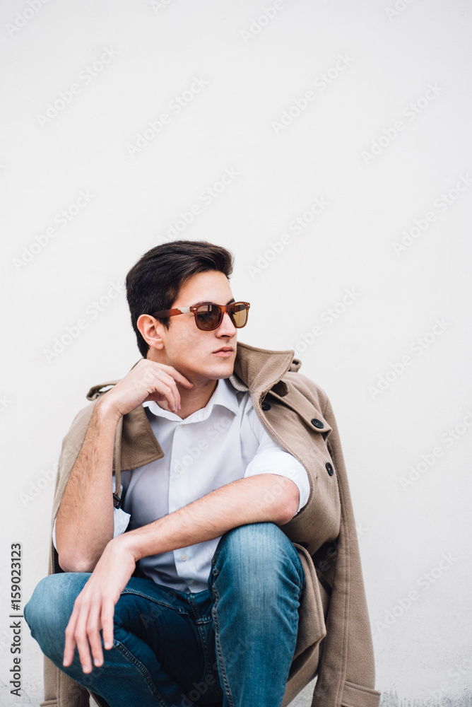 Portrait of young stylish man against the white wall Portrait of young stylish man against the white wall