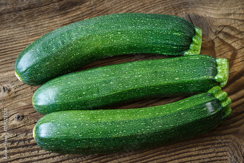 Fresh zucchini on rustic wooden table