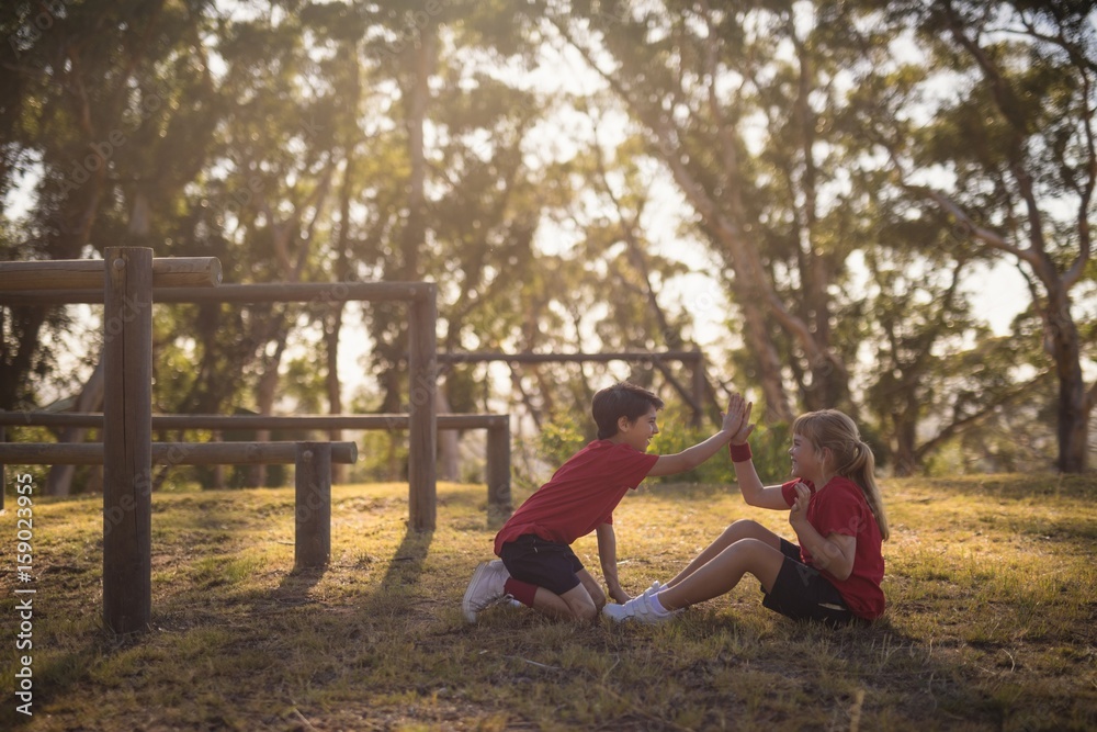 Kids giving high five to each other while exercising Kids giving high five to each other while exercising