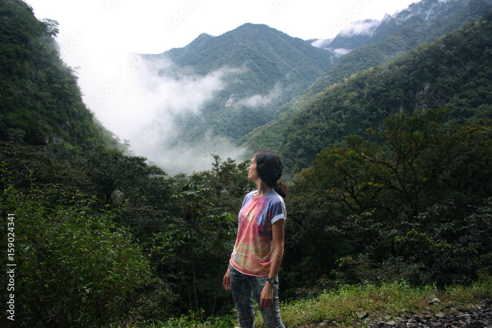 mid age woman looking at mountains in jungle, Peru