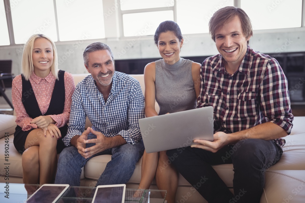 Portrait of smiling business people working on laptop at office Portrait of smiling business people working on laptop at office