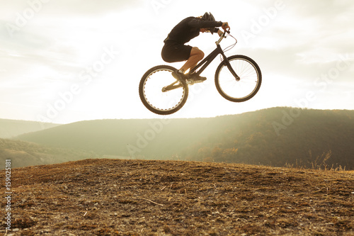 Male biker in moment of jumping