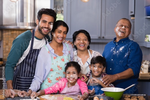 Portrait of cheerful multi-generation family enjoying in kitchen