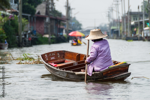 Woman at floating market © ryanwcurleyphoto