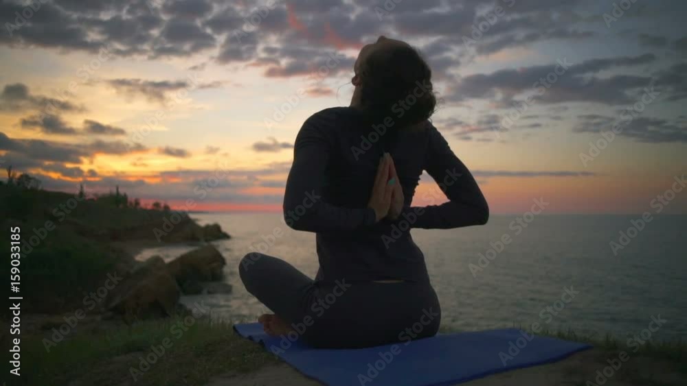 Peaceful girl doing namaste yoga pose meditate sunrise coast slow motion Peaceful girl doing namaste yoga pose meditate sunrise coast slow motion