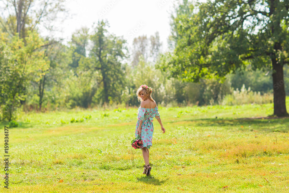 Portrait of the young beautiful romantic woman in dress outdoors Portrait of the young beautiful romantic woman in dress outdoors