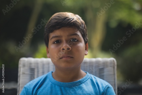 Portrait of serious boy sitting on chair © WavebreakMediaMicro
