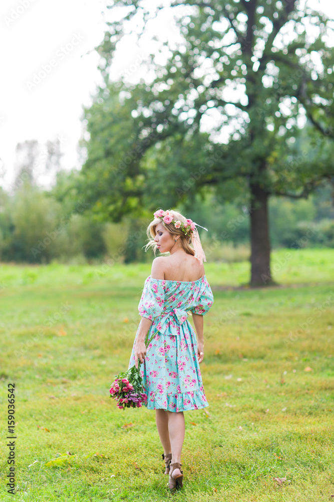 Portrait of the young beautiful romantic woman in dress outdoors Portrait of the young beautiful romantic woman in dress outdoors