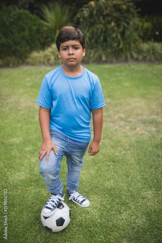 Portrait of upset boy standing with soccer ball at park © WavebreakMediaMicro