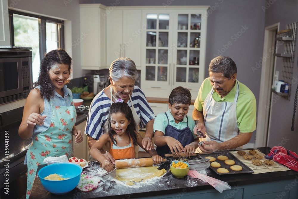 Happy family preparing dessert in kitchen Happy family preparing dessert in kitchen