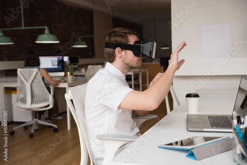 Male executive using virtual reality headset 