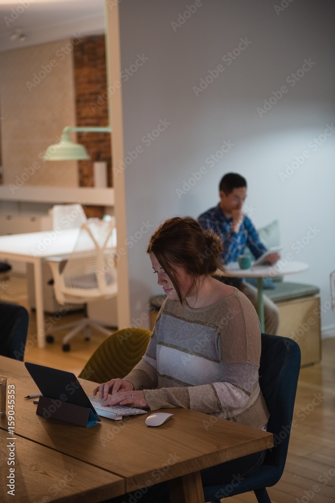 Female executive using digital tablet at desk Female executive using digital tablet at desk