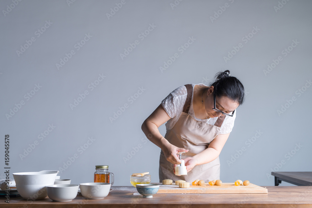 A young woman is making moon cake at home A young woman is making moon cake at home