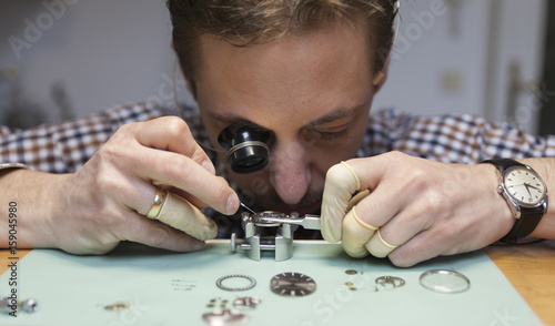 Clockmaker working in workshop