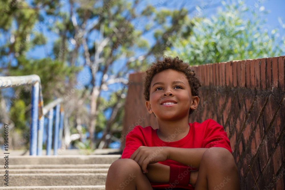 Boy sitting on staircase in the boot camp Boy sitting on staircase in the boot camp