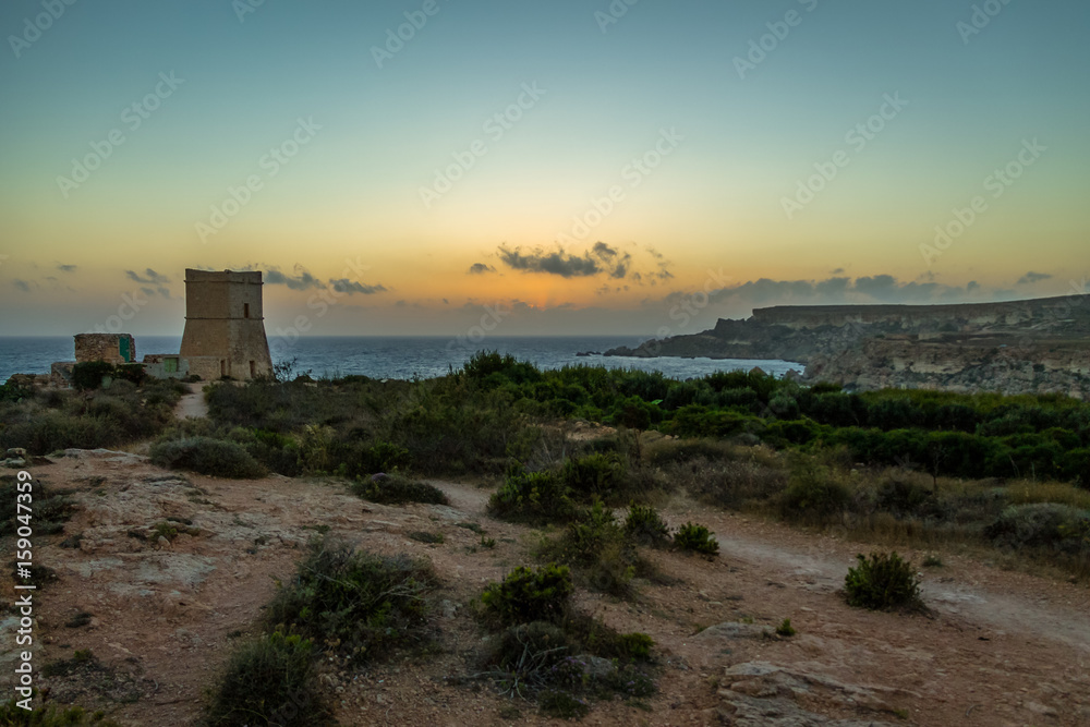 Ghajn Tuffieha Tower in Golden Bay at sunset - Malta