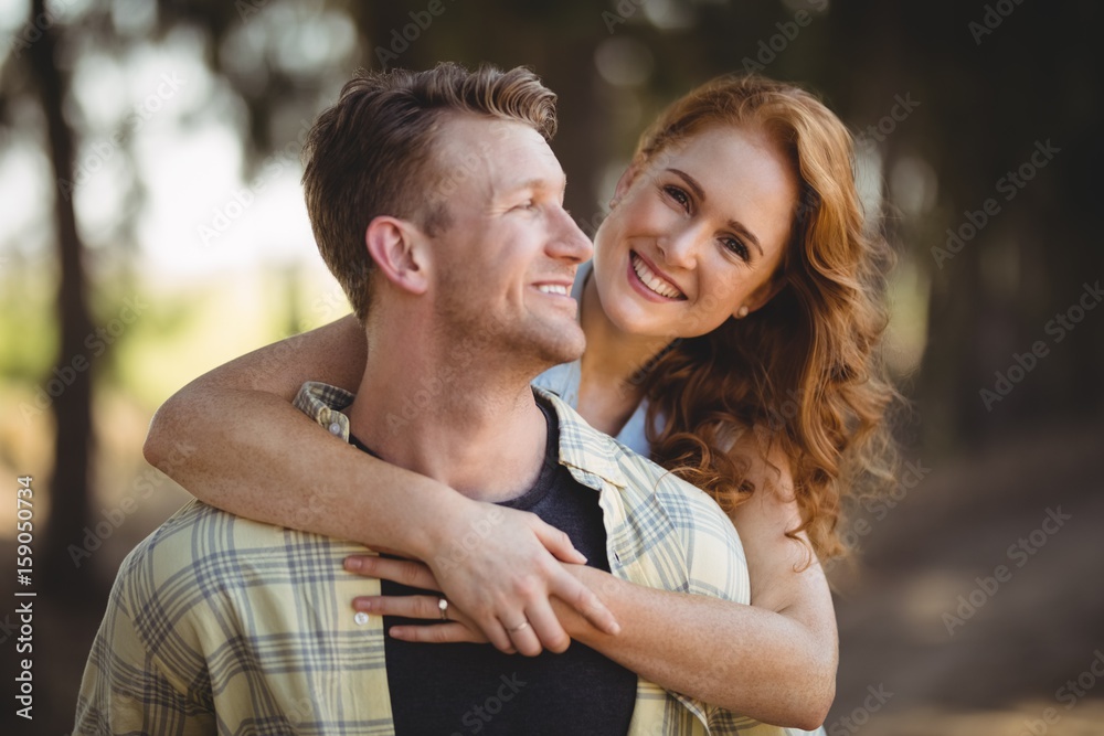 Obraz premium Smiling woman embracing man at olive farm