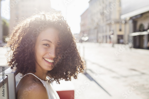 Portrait of beautiful curly woman  smiling photo