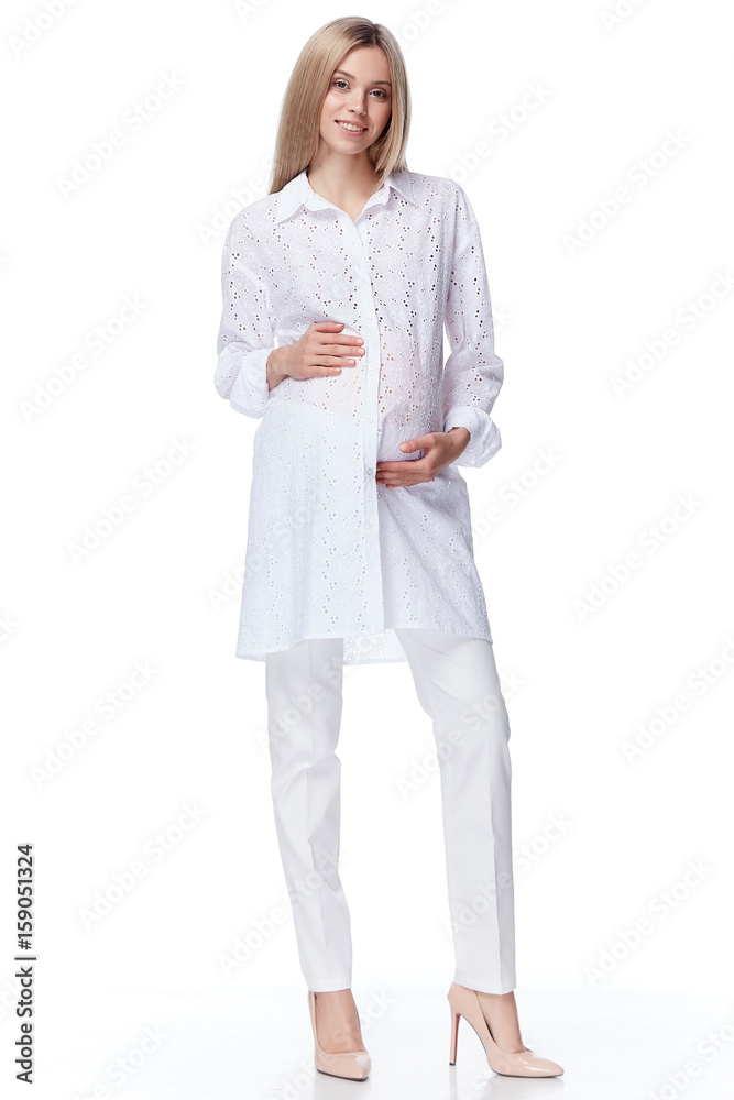 Beautiful elegant pregnant woman blond hair wear style fashion blouse pants mother hold in hand tummy wait for baby child new born pretty lady clothes for pregnancy white background collection heath. Beautiful elegant pregnant woman blond hair wear style fashion blouse pants mother hold in hand tummy wait for baby child new born pretty lady clothes for pregnancy white background collection heath.