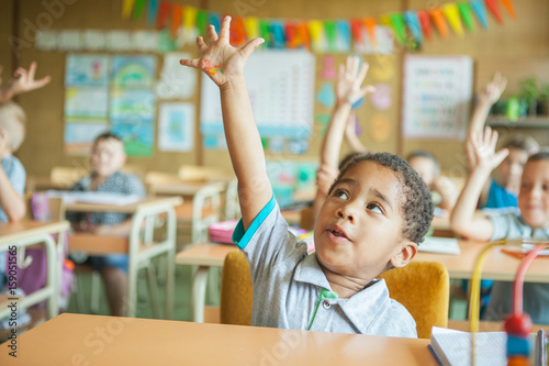 Primary School Students Raising Hands