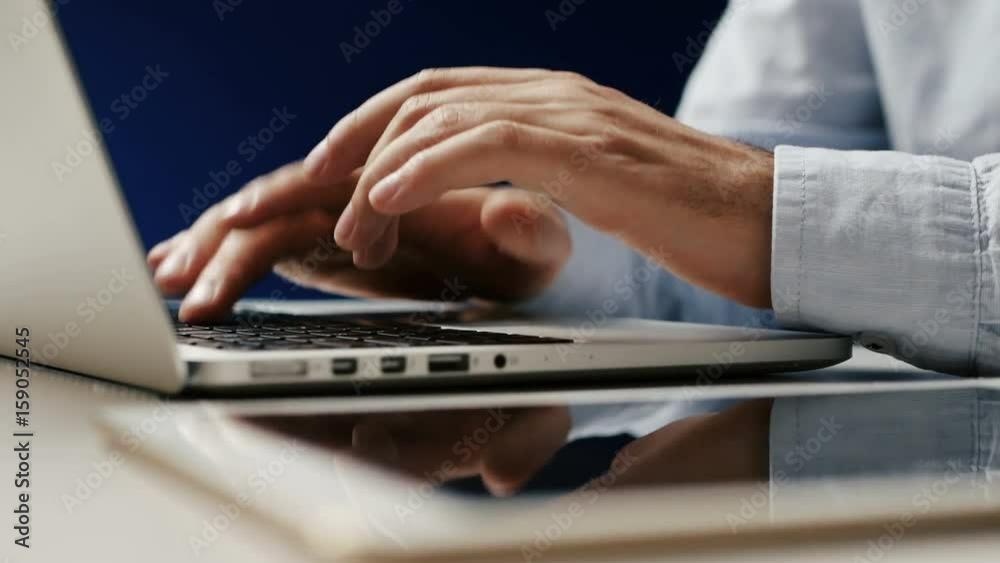 Hands touch typing on a laptop keyboard. white background Hands touch typing on a laptop keyboard. white background