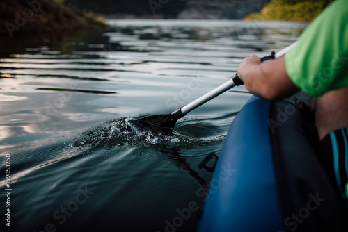 Close up of a man with a paddle on the lake