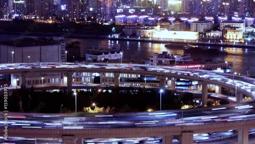 freeway busy city rush hour heavy traffic jam highway Shanghai at night,the light trails of traffic on overpass,time lapse,Brightly lit urban morden building,busy shipping sailing on huangpu river. freeway busy city rush hour heavy traffic jam highway Shanghai at night,the light trails of traffic on overpass,time lapse,Brightly lit urban morden building,busy shipping sailing on huangpu river.