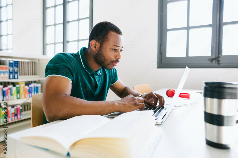 African american man studying in a library African american man studying in a library