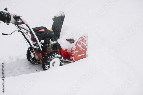 Snow removal with a snowblower photo