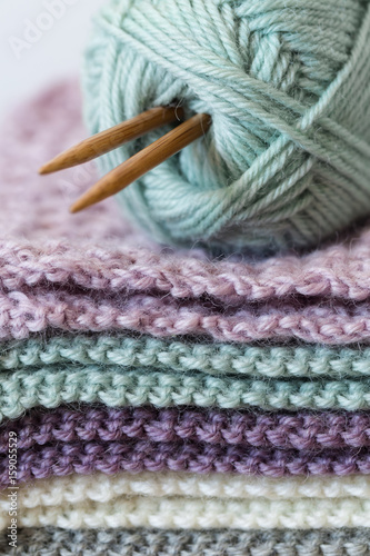 Close up of knitting project with ball of wool and knitting needles - vertical
