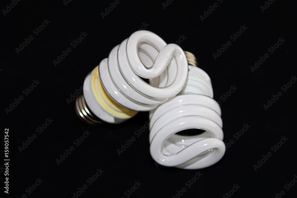 Closeup of two fluorescent light bulbs isolated on a black background Closeup of two fluorescent light bulbs isolated on a black background