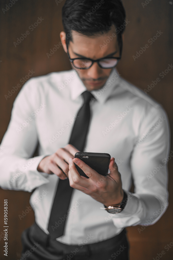 Businessman using mobile phone in office Businessman using mobile phone in office