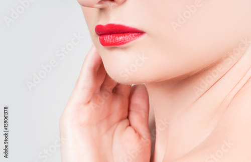 Beautiful woman neck with clean skin and red lips