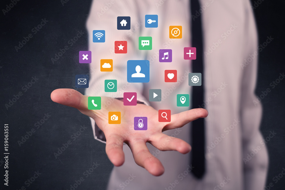 Businessman holding colorful applications Businessman holding colorful applications