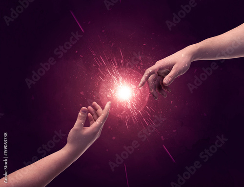 Touching hands light up sparkle in space