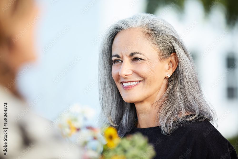 Portrait of senior woman with group of friends enjoying a Farm To Table Dinner Party in backyard Portrait of senior woman with group of friends enjoying a Farm To Table Dinner Party in backyard