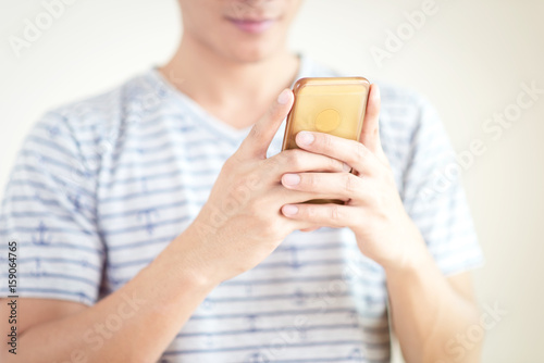 Hand holding using mobile phone.Close up of man using smart phone.Vintage filter
