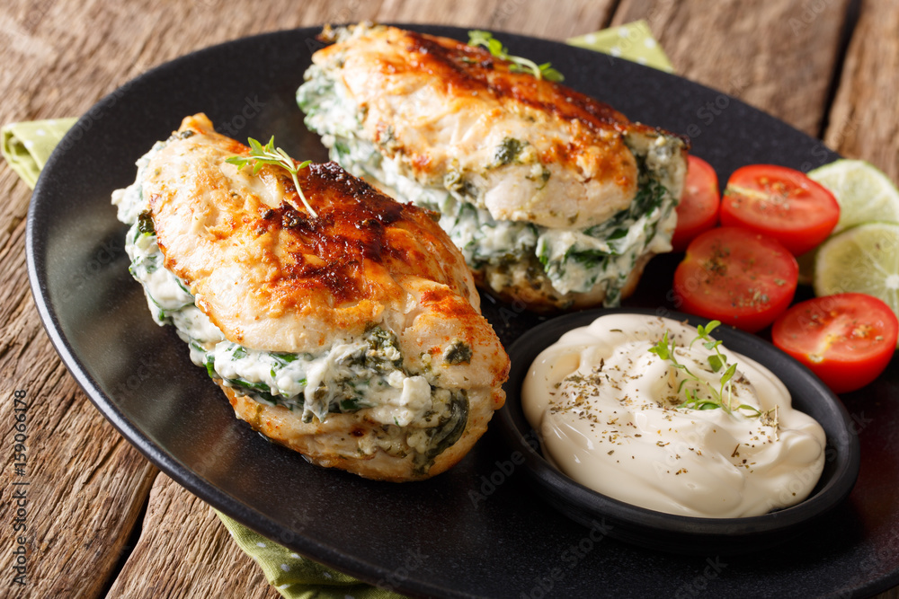 Delicious food: Baked chicken fillet stuffed with cheese and spinach close-up. horizontal Delicious food: Baked chicken fillet stuffed with cheese and spinach close-up. horizontal