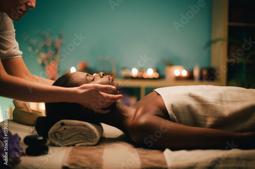 Woman receiving a head massage at spa photo