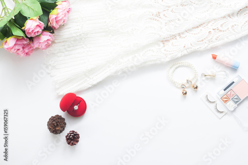 Flat lay of Bride essentials and engagement ring on white background